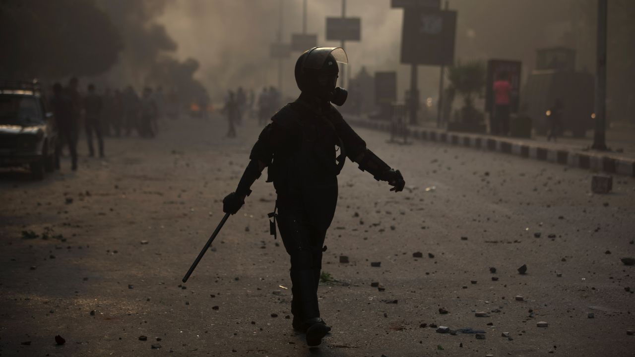 A riot police officer moves into position during clashes on October 6 in Cairo.