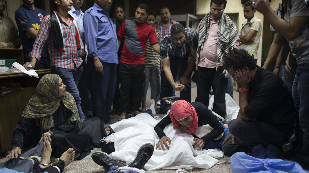 People mourn over the bodies of lost relatives on October 6 in Cairo.