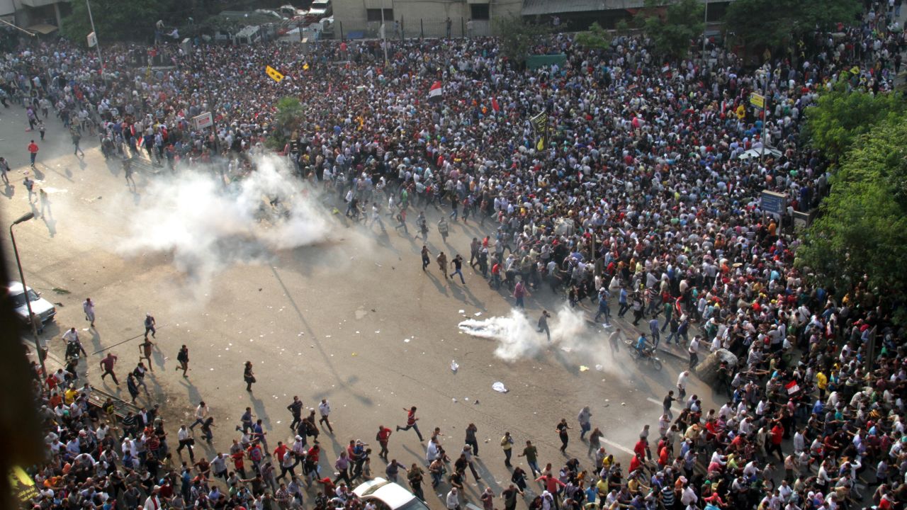 Morsy supporters run from tear gas along a street in downtown Cairo on October 6.