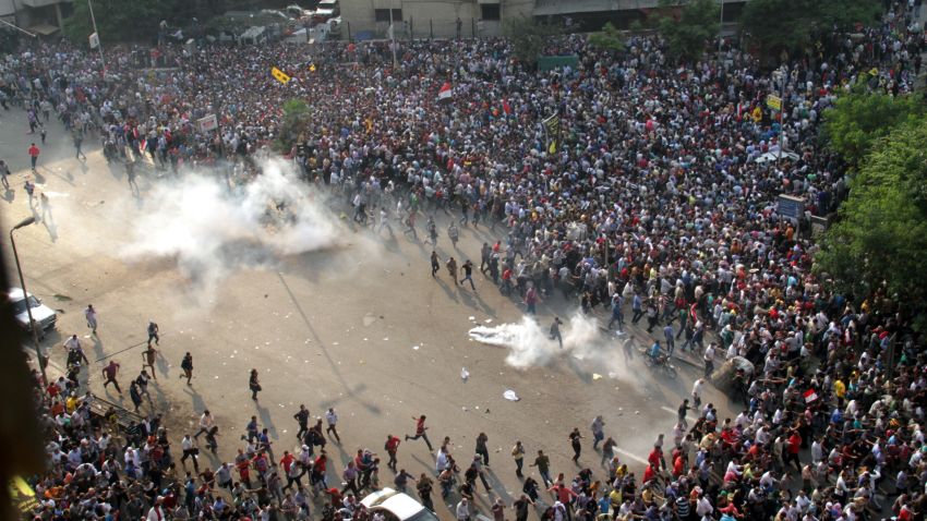 Morsy supporters run from tear gas along Ramsis Street in Cairo.