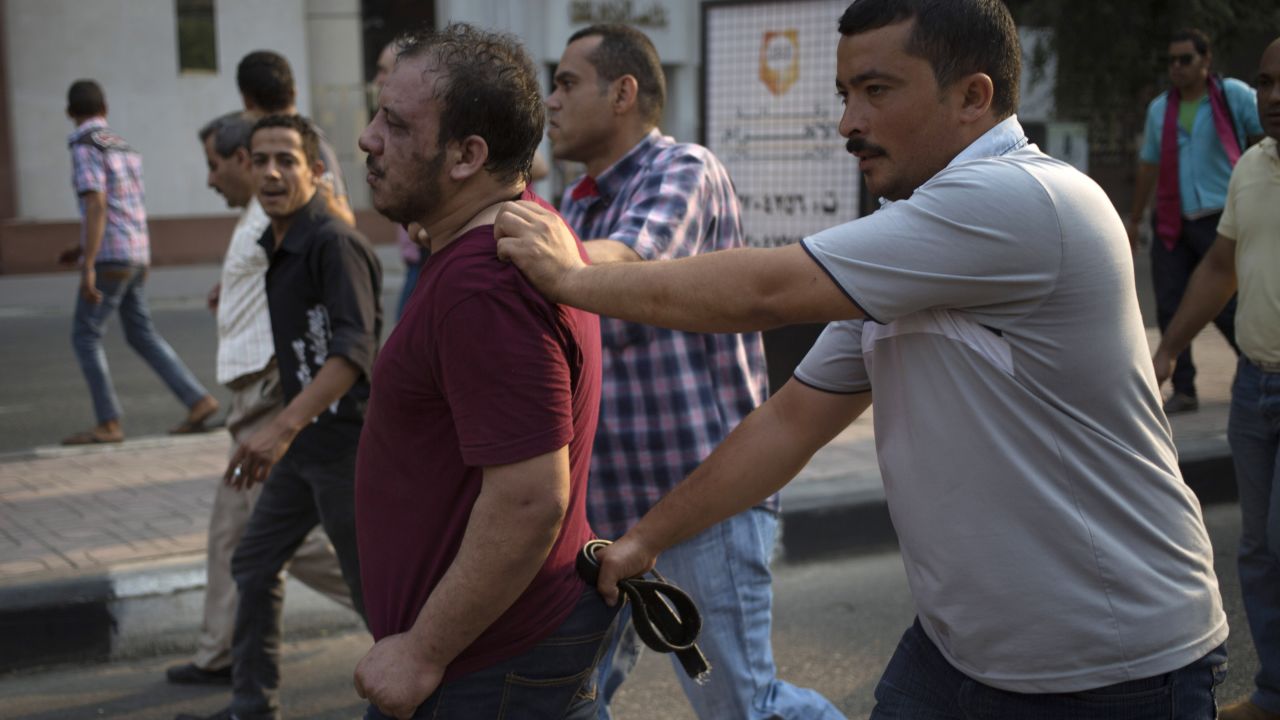 Egyptian security forces detain a suspected Morsy supporter in Cairo on October 6.
