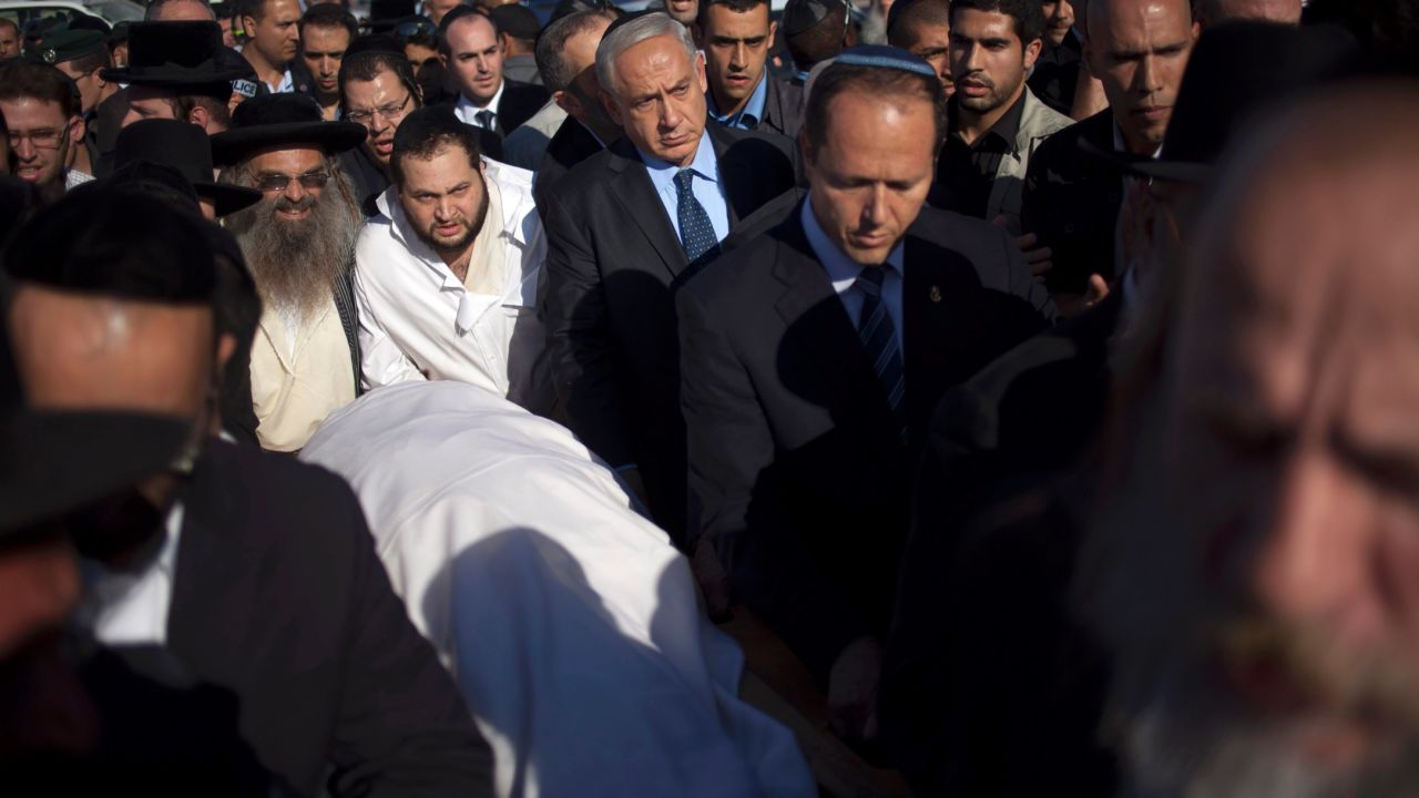 Israeli Prime Minister Benjamin Netanyahu, center, escorts Yosef's body during the rabbi's funeral in Jerusalem on October 7.