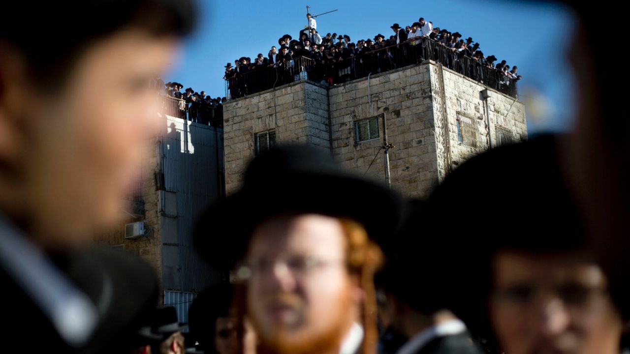 Orthodox Jews watch Yosef's funeral procession on October 7 in Jerusalem.