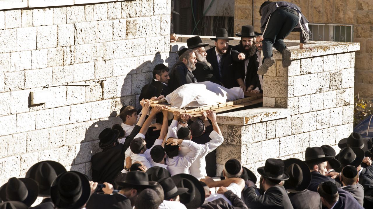 Yosef's body gets carried up stairs during the funeral procession.