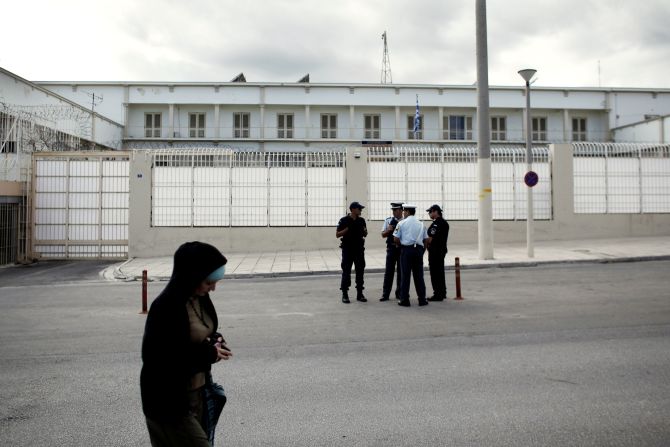 Police stand in front of the Korydallos high-security prison on October 3, 2013 before the transfer of Michaloliakos, pending his trial on criminal charges.