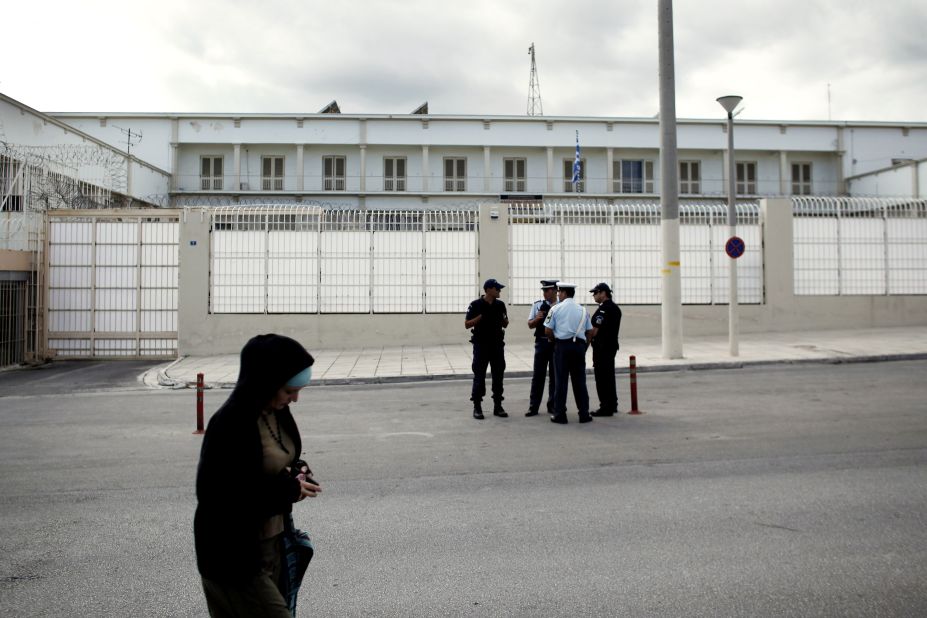 Police stand in front of the Korydallos high-security prison on October 3, 2013 before the transfer of  Michaloliakos, pending his trial on criminal charges. 