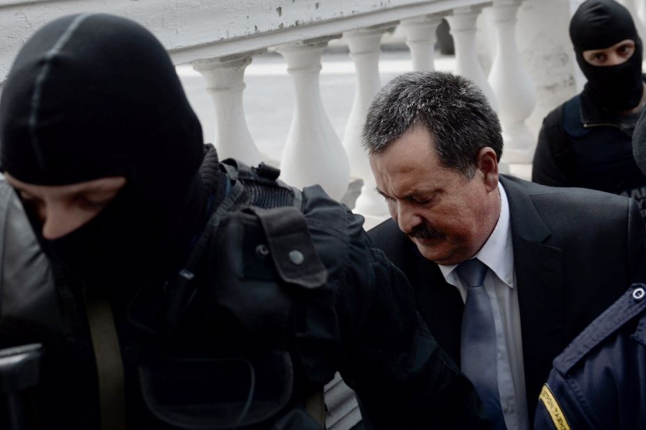 Greek Golden Dawn lawmaker Christos Pappas is escorted to a court in Athens on October 3, 2013. Pappas, the second most powerful figure in Greece's neo-Nazi Golden Dawn party was taken into custody after he was charged with helping to run a criminal organization.