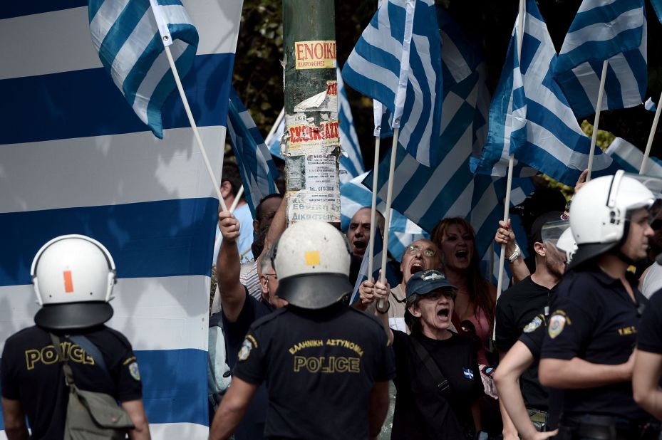 Supporters of Golden Dawn shout slogans outside a court in Athens on October 2, 2013.