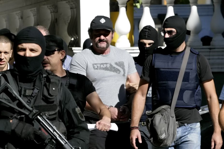 Extreme-right Golden Dawn party lawmaker Ioannis Lagos is escorted by anti-terror police after judicial authorities sent him to jail ahead of his trial, on October 2, 2013 in Athens, Greece.