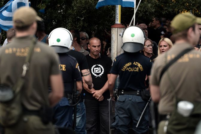 Greece's Golden Dawn supporters gather outside an Athens court on October 2, 2013 as four lawmakers from the neo-Nazi party were charged with belonging to a criminal organization.