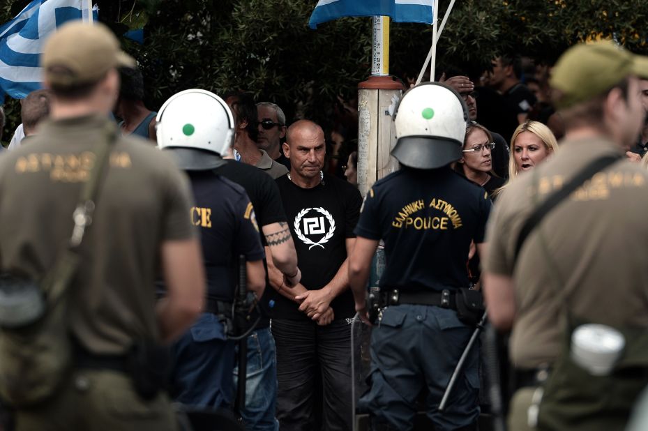 Greece's Golden Dawn supporters gather outside an Athens court on October 2, 2013 as four lawmakers from the neo-Nazi party were charged with belonging to a criminal organization. 