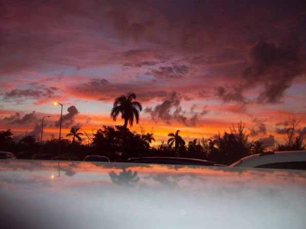 Scott Stransky, a natural disaster surveyor, captured a glimpse of beauty while investigating the aftermath of Hurricane Irene in August 2011. "This photo was taken in the parking lot at sunrise at Nassau International Airport in the Bahamas, with the scene reflecting slightly off the roof of my rental car."