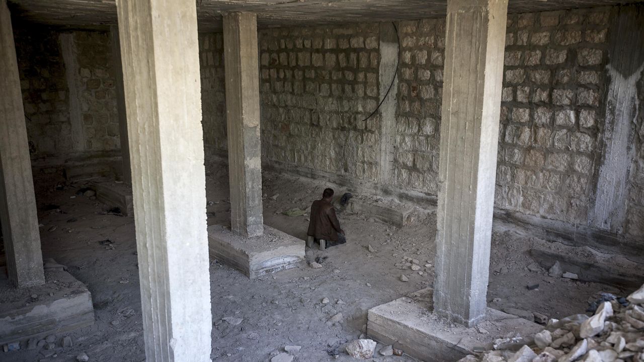 A rebel fighter prays moments before heading into battle in Maaret al-Numan, Syria, on Monday, October 7.