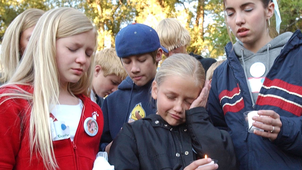 Smart's cousins Tori Dumke, from left, Cessilee Smart and Alicia Smart join supporters during a candlelight vigil in June 2002 in Salt Lake City.