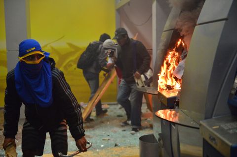 Masked protesters destroyed cash dispensers during the Rio protests on October 7.