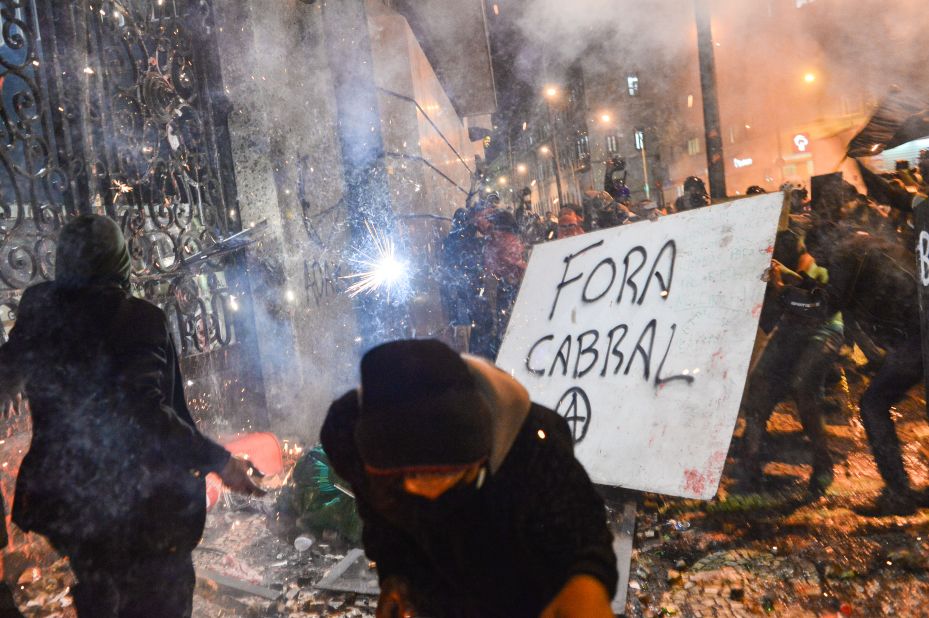 Masked protesters attempted to destroy a gate of the Rio de Janeiro City Hall on October 7.