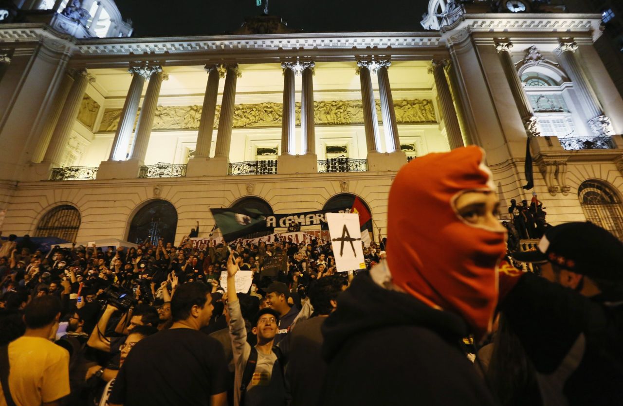 A masked man joins demonstrators in front of a government building during last October's protests in Rio.