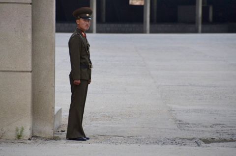 A stern looking North Korean guard by the Chinese border customs office. This image was deleted by North Korean officials. 
