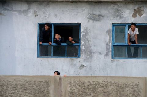In the city of Rason, people are leaning out of windows to get a glimpse of the Western cyclists. 