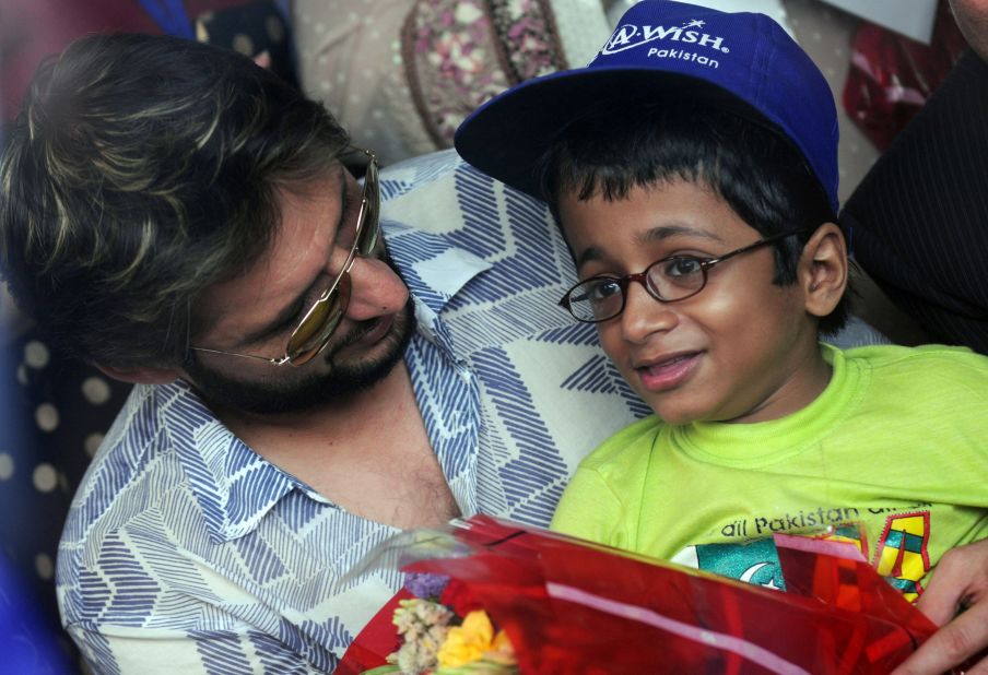 Former Pakistani cricket captain Shahid Afridi chats with a polio-afflicted child during a 'Make A Wish' event in Karachi 18 June, 2011. 