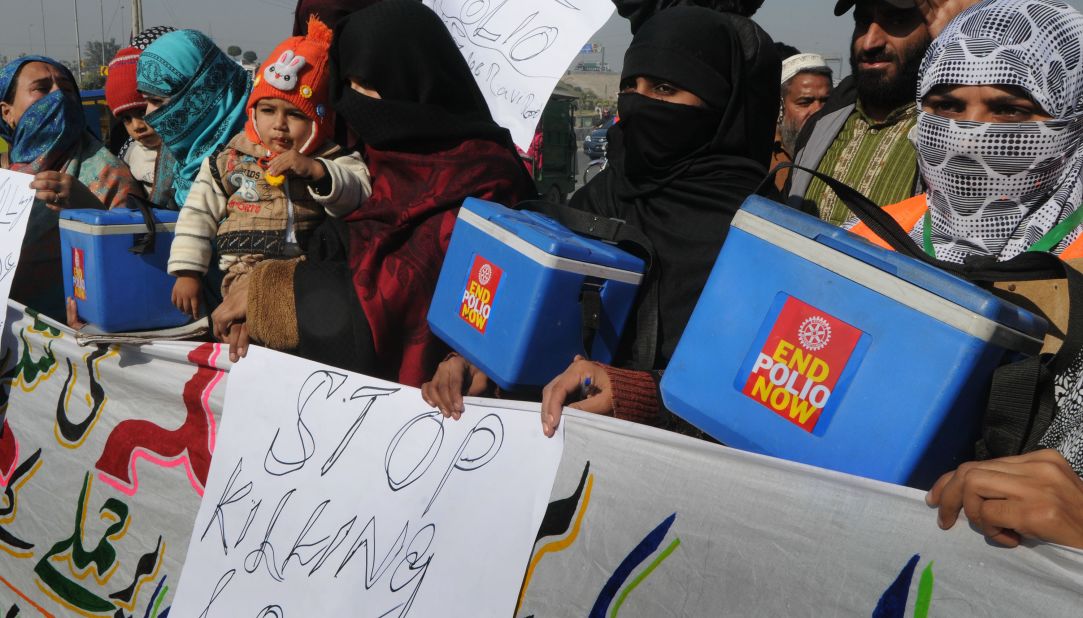 Pakistani polio vaccination workers carry placards during a protest against the killing of their colleagues in Lahore on December 21, 2012. 