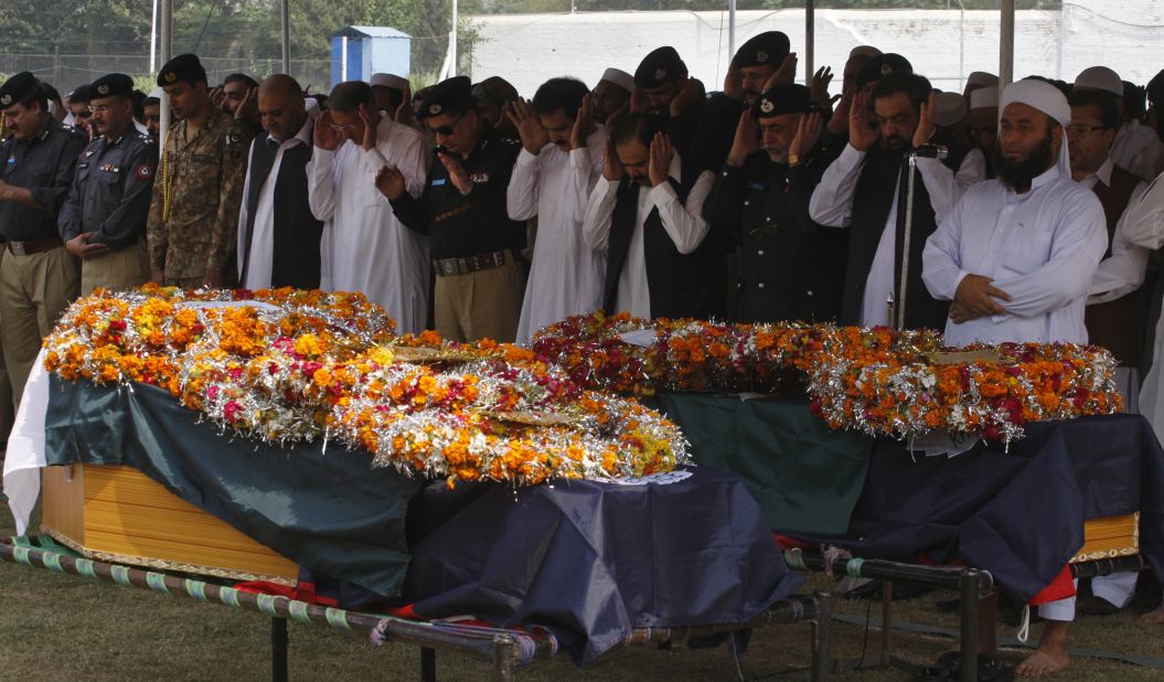 People attend funeral prayers for victims of an explosion in Peshawar, Pakistan, Monday, October 7, 2013. A bomb exploded next to a van carrying Pakistani security guards tasked with protecting workers involved in an anti-polio drive in the country's northwest on Monday.