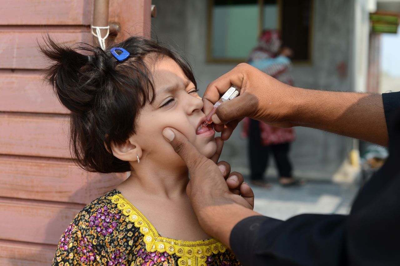 A Pakistani child receives an oral polio vaccine during an anti-polio campaign in Rawalpindi on October 1, 2013. The Polio virus saw a huge surge in year 2011, with as many as 198 cases reported from different parts of the country, forcing the government to enhance the immunization in affected regions.