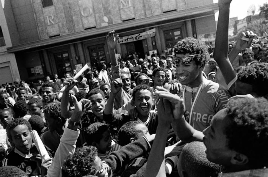 Eritrea's Daniel Telehaimanot, the country's most popular cyclist, is mobbed by spectators in front of Asmara's Roma Theatre after finishing second in the Giro dell'Eritrea -  a 700-mile, 10-stage event, that is Africa's oldest cycle race.