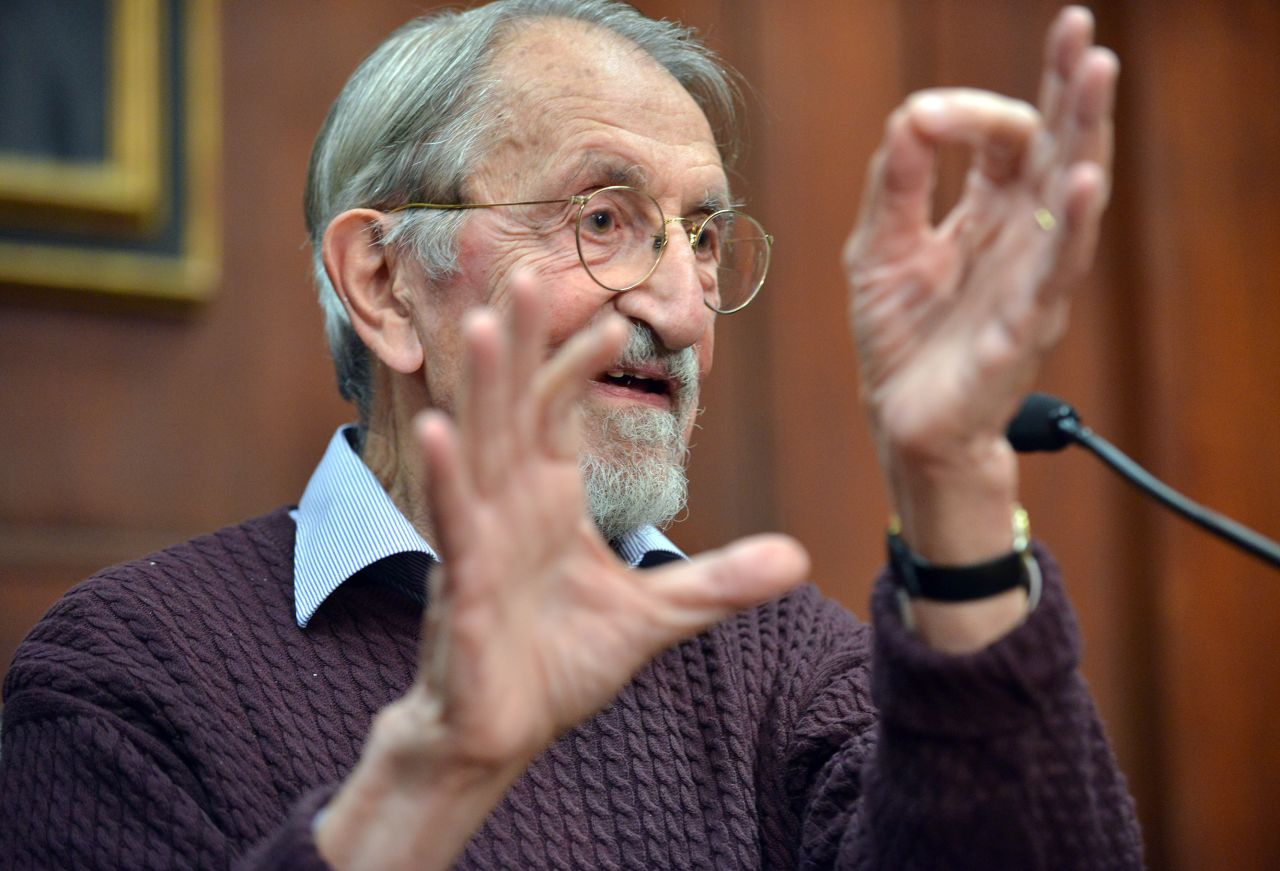 Martin Karplus describes molecular behavior as he speaks to reporters at Harvard University in Cambridge, Massachusetts, after being awarded the Nobel Prize in chemistry on October 9.  The three men's work allows researchers to study chemical reactions, which take place very quickly, at a slower pace using a computer. 