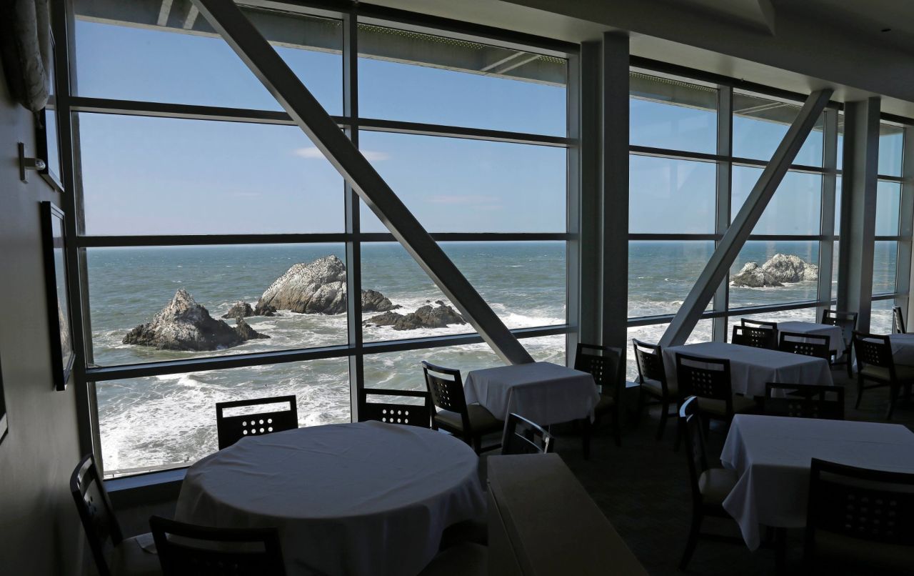 Empty tables overlooking Seal Rocks are seen inside the closed Cliff House on Wednesday, October 9, in San Francisco. The 150-year-old oceanside icon was ordered closed by the National Park Service for the duration of the partial government shutdown, leaving most of the restaurant's 170 employees without work.