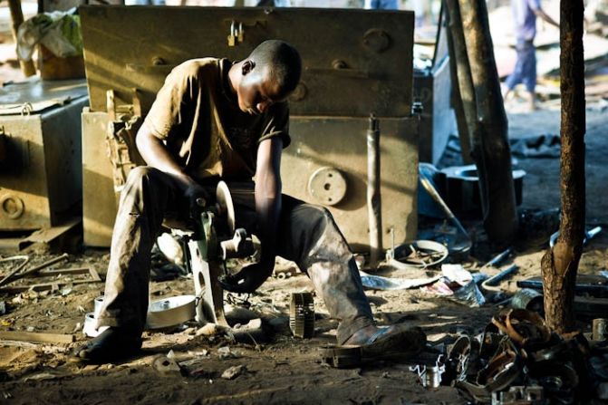 Mahamadou, 17, grinds metal parts that have just been moulded in Bamako, Mali. Every day he works from 7 a.m. to 6 p.m. recycling scrap metal to everyday objects. He never went to school and, like more than seven out of ten Malians aged 15 or older, is illiterate. His knowledge, instead, came from his father and grandfather, both of whom were blacksmiths.