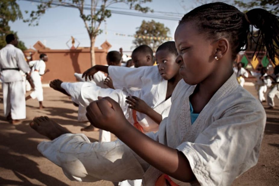 Jeannette Nikiéma, 13, practices karate at a martial arts school three times a week in Burkina Faso, West Africa. Karate, though not as popular as boxing, is well established in the country. Though usually nothing more than a spartan space with no real teacher, they attract young people eager to copy the moves they have seen on action films from Asia at their local video club.