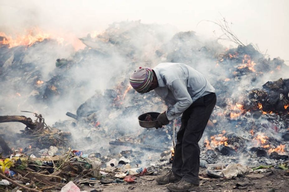 A migrant worker scavenges for materials in a landfill in the Maldives. Thilafushi is an artificial island created by filling one of the Maldives' shallow lagoons with garbage. More than 300 tons of rubbish are brought to Thilafushi each day. Workers earn US$300 a month by burning the rubbish and selling scavenged materials.
