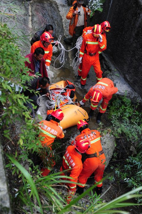 Rescuers carry Kovats' body down a steep path in Tianmen Mountain National Forest Park on October 9. Kovats jumped at 2:51 p.m. local time, according to news agency Xinhua.