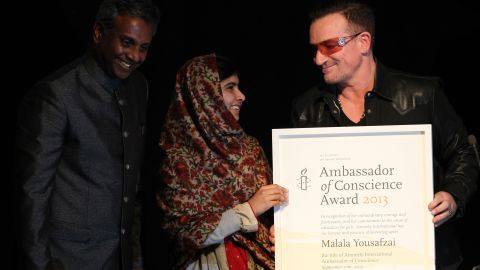 Musician Bono, right, and Salil Shetty, the secretary general of Amnesty International, honor Malala with the Amnesty International Ambassador of Conscience Award at the Manison House in Dublin, Ireland, in September 2013. The award is Amnesty International's highest honor, recognizing individuals who have promoted and enhanced the cause of human rights.