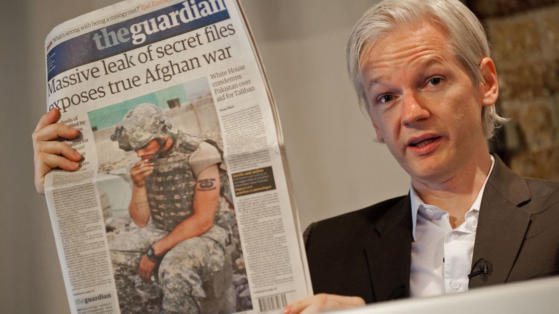 Julian Assange holds up a copy of The Guardian newspaper in London, England on July 26, 2010.