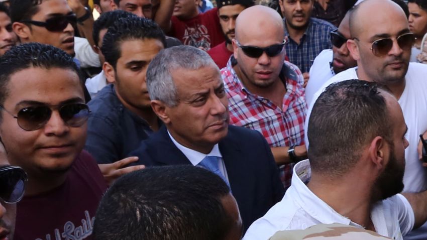 Libyan Prime Minister Ali Zeidan (C) arrives at the government headquarters in Tripoli on October 10, 2013 shortly after he was freed from the captivity of militiamen who had held him for several hours. Gunmen seized Zeidan from a hotel, where he resides, in the Libyan capital and held him for several hours before he was freed, in the latest sign of Libya's lawlessness since Moamer Kadhafi was toppled in 2011. AFP PHOTO / MAHMUD TURKIA (Photo credit should read MAHMUD TURKIA/AFP/Getty Images)