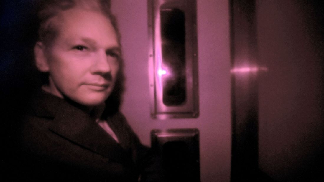 Assange sits behind the tinted window of a police vehicle in London on December 14, 2010. Assange had turned himself in to London authorities on December 7 and was released on bail and put on house arrest on December 16. In February 2011, a judge ruled in support of Assange's extradition to Sweden. Assange's lawyers filed an appeal.