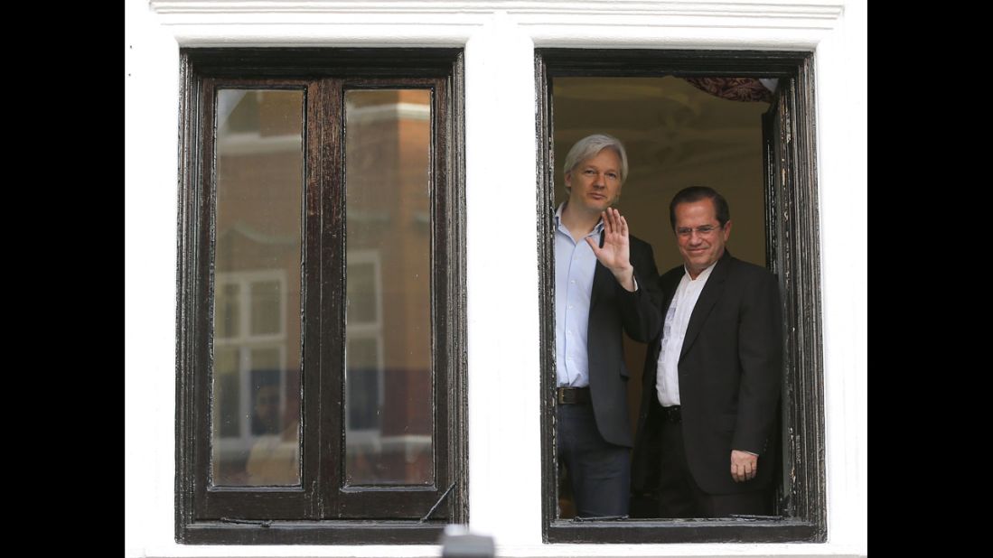 Assange appears with Ecuadorian Foreign Minister Ricardo Patino on the balcony of the embassy in June 2013.