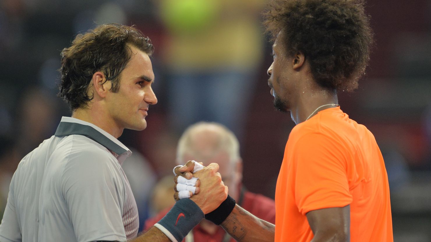Gael Monfils of France (right) shakes hands with Roger Federer after winning their third-round match at the Shanghai Masters.
