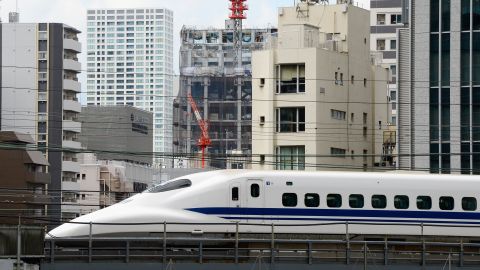 A "shinkansen" or bullet train speeds amongst buildings in Tokyo. 