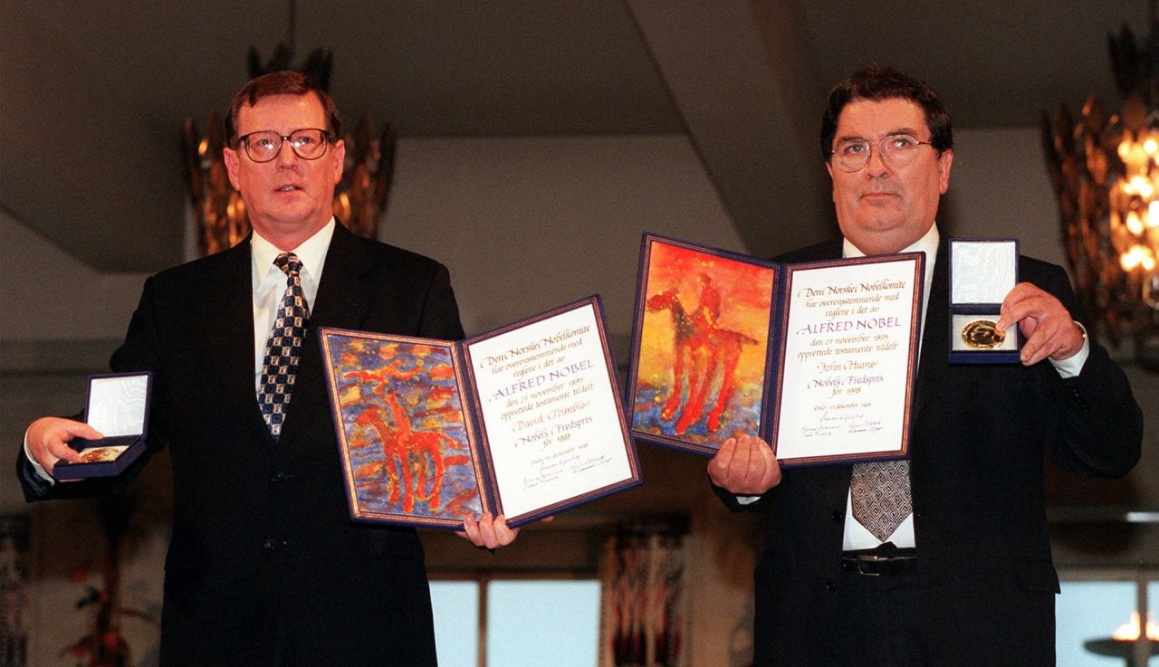 David Trimble, left, and John Hume hold up their diplomas and medals after receiving their Nobel Peace Prize in Oslo, Norway, on December 10, 1998. Trimble and Hume won the Nobel Peace Prize in 1998. 