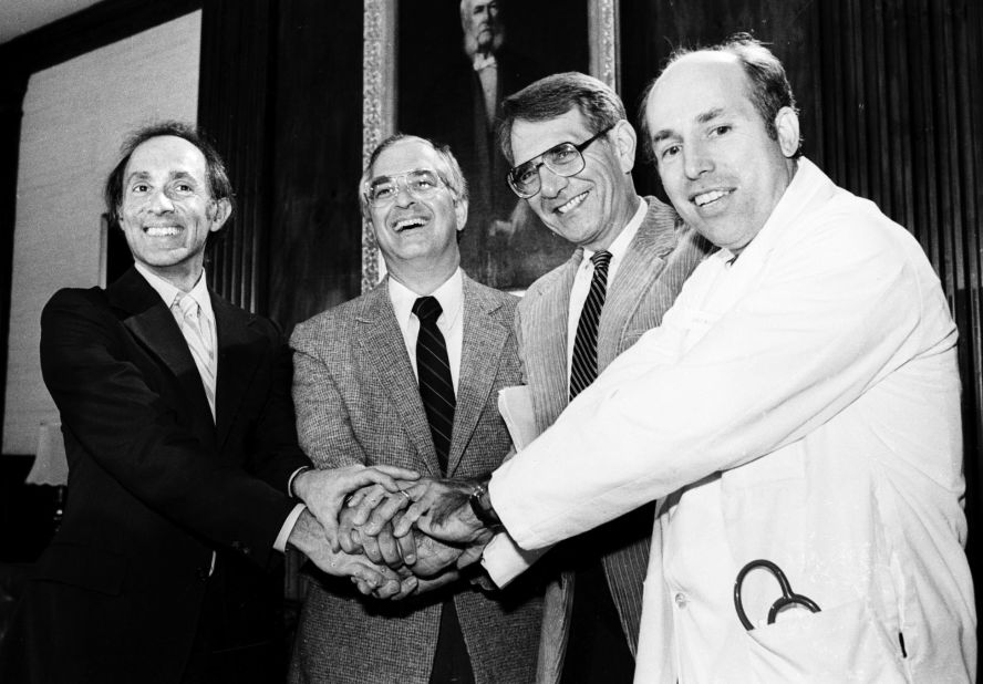 Members of the International Physicians for the Prevention of Nuclear War clasp hands on October 11, 1985, at the group's Boston headquarters after the organization was awarded the 1985 Nobel Peace Prize. The doctors are, from left, Eric Chivian, co-founder; John Pastore, secretary; Sidney Alexander, president of the U.S. affiliate group; and James Muller, co founder. 
