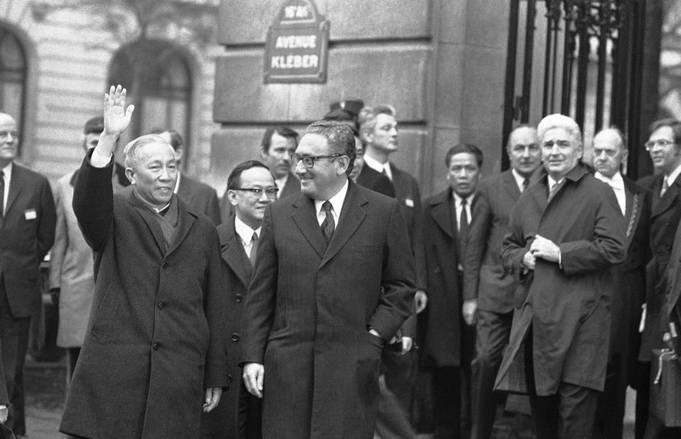 Hanoi's delegate Le Duc Tho cheers to the crowd while leaving the International Conference Center in Paris on January 23, 1973, after meeting with presidential adviser Henry Kissinger, center. Le Duc Tho and Kissinger won the Nobel Peace Prize in 1973. 