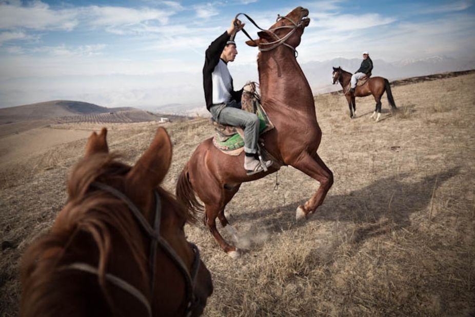 Suhrob exercises one of the horses in preparation for Buzkashi -- a Central Asian sport where up to a hundred or more riders fight to seize a headless goat carcass then carry it to a goal. As is common in the buzkashi world, rather than riding their own horses, Suhrob and his brothers ride animals owned by a wealthy individual.