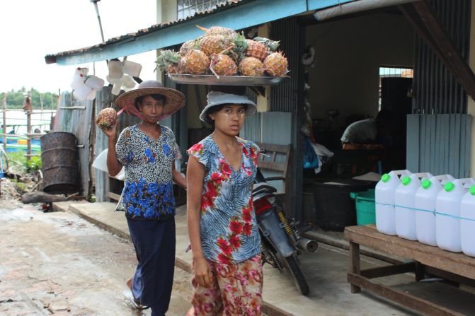 Women in Bogale take pineapples from boats on the nearby river to street markets to sell. Bogale is virtually surrounded by water and was one of the townships hardest hit by Cyclone Nargis in 2008.