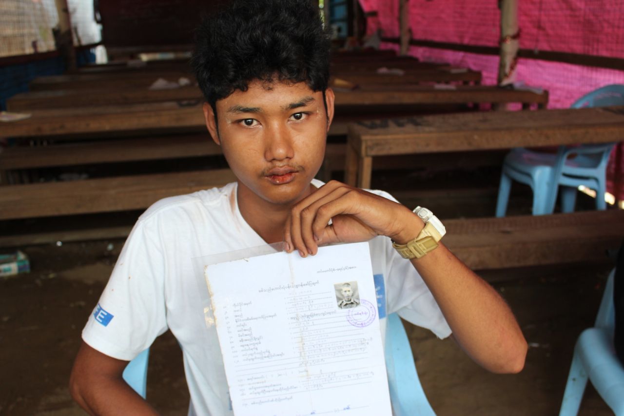 Zaw Min Paing poses with his army documentation. He was recruited at the age of 15 and spent more than four months in a training center before being released to his parents. He's now 19 and has given up hope of ever finishing school.