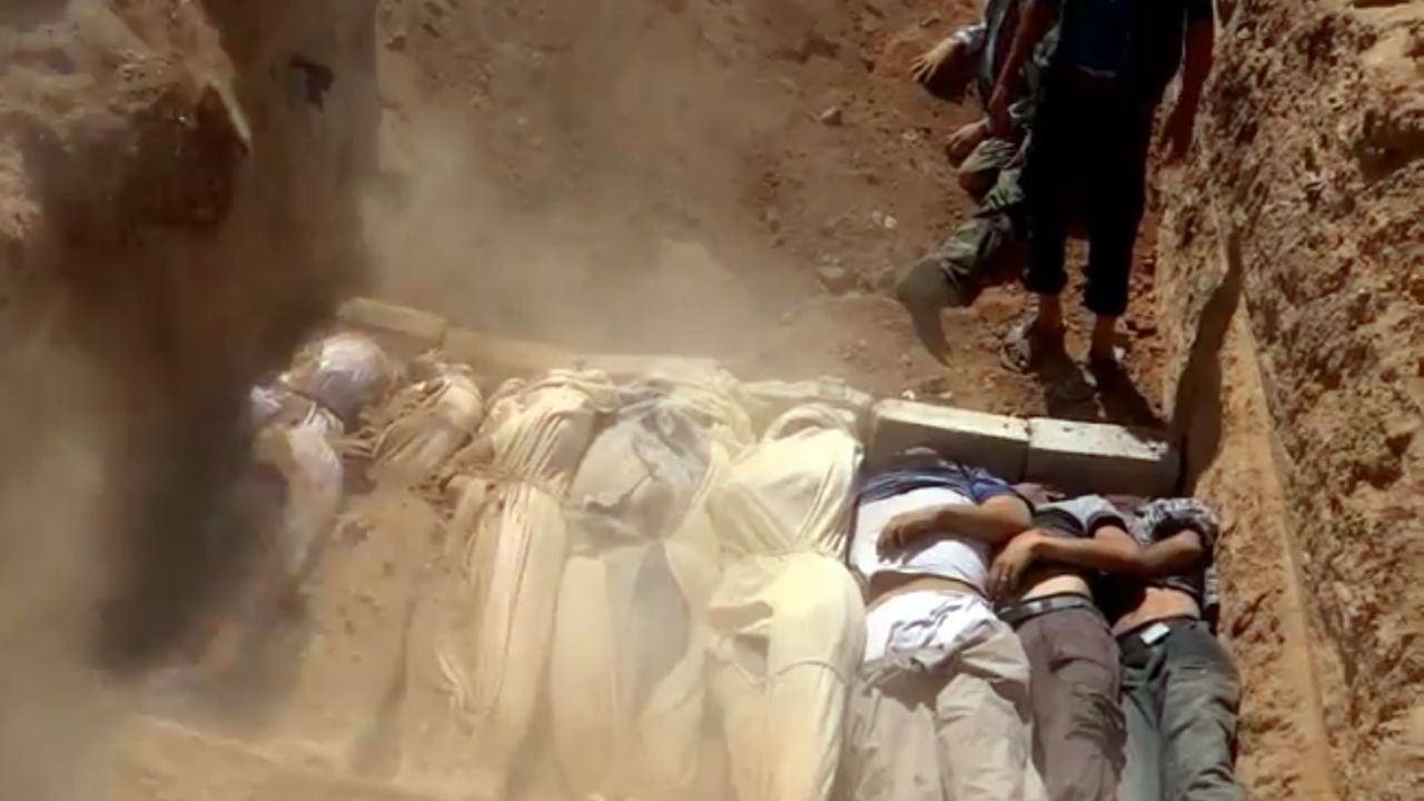 An image grab taken from a video uploaded on YouTube by the Local Committee of Arbeen on August 21, 2013 allegedly shows Syrians covering a mass grave containing bodies of victims that Syrian rebels claim were killed in a toxic gas attack by pro-government forces in eastern Ghouta and Zamalka, on the outskirts of Damascus. The allegation of chemical weapons being used in the heavily-populated areas came on the second day of a mission to Syria by UN inspectors, but the claim, which could not be independently verified, was vehemently denied by the Syrian authorities, who said it was intended to hinder the mission of UN chemical weapons inspectors. AFP PHOTO / YOUTUBE / LOCAL COMMITTEE OF ARBEEN== RESTRICTED TO EDITORIAL USE - MANDATORY CREDIT 'AFP PHOTO / YOUTUBE / LOCAL COMMITTEE OF ARBEEN' - NO MARKETING NO ADVERTISING CAMPAIGNS - DISTRIBUTED AS A SERVICE TO CLIENTS - AFP IS USING PICTURES FROM ALTERNATIVE SOURCES AS IT WAS NOT AUTHORISED TO COVER THIS EVENT, THEREFORE IT IS NOT RESPONSIBLE FOR ANY DIGITAL ALTERATIONS TO THE PICTURE'S EDITORIAL CONTENT, DATE AND LOCATION WHICH CANNOT BE INDEPENDENTLY VERIFIED == (Photo credit should read DSK/AFP/Getty Images)
