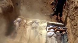 An image grab taken from a video uploaded on YouTube by the Local Committee of Arbeen on August 21, 2013 allegedly shows Syrians covering a mass grave containing bodies of victims that Syrian rebels claim were killed in a toxic gas attack by pro-government forces in eastern Ghouta and Zamalka, on the outskirts of Damascus. The allegation of chemical weapons being used in the heavily-populated areas came on the second day of a mission to Syria by UN inspectors, but the claim, which could not be independently verified, was vehemently denied by the Syrian authorities, who said it was intended to hinder the mission of UN chemical weapons inspectors. AFP PHOTO / YOUTUBE / LOCAL COMMITTEE OF ARBEEN== RESTRICTED TO EDITORIAL USE - MANDATORY CREDIT 'AFP PHOTO / YOUTUBE / LOCAL COMMITTEE OF ARBEEN' - NO MARKETING NO ADVERTISING CAMPAIGNS - DISTRIBUTED AS A SERVICE TO CLIENTS - AFP IS USING PICTURES FROM ALTERNATIVE SOURCES AS IT WAS NOT AUTHORISED TO COVER THIS EVENT, THEREFORE IT IS NOT RESPONSIBLE FOR ANY DIGITAL ALTERATIONS TO THE PICTURE'S EDITORIAL CONTENT, DATE AND LOCATION WHICH CANNOT BE INDEPENDENTLY VERIFIED == (Photo credit should read DSK/AFP/Getty Images)