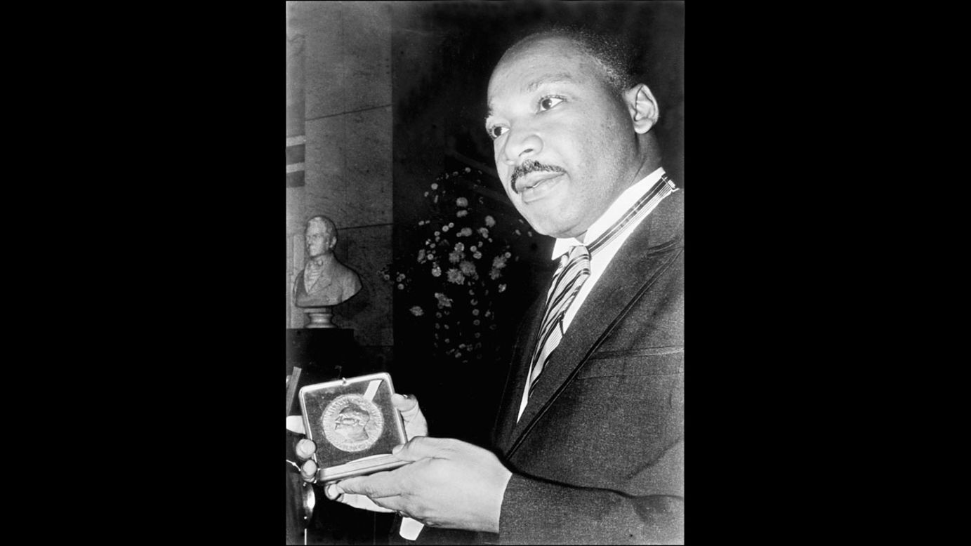 The Rev. Martin Luther King Jr. displays his Nobel Peace Prize medal in December 1964 in Oslo, Norway. Then 35, King was the youngest man to have received the prize. The U.S. civil rights leader was slain in 1968.
